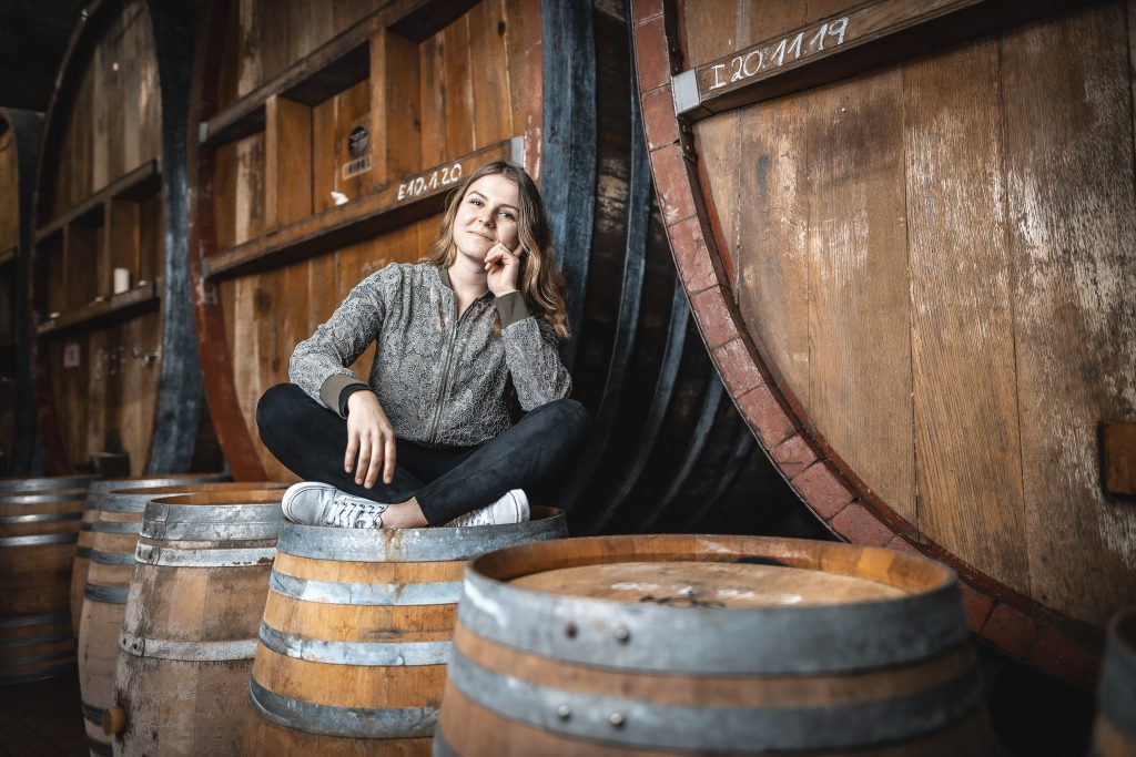Starke Frauen: Sophie Kuhnle sitzt im Weinkeller der Remstalkellerei auf einem Weinfass